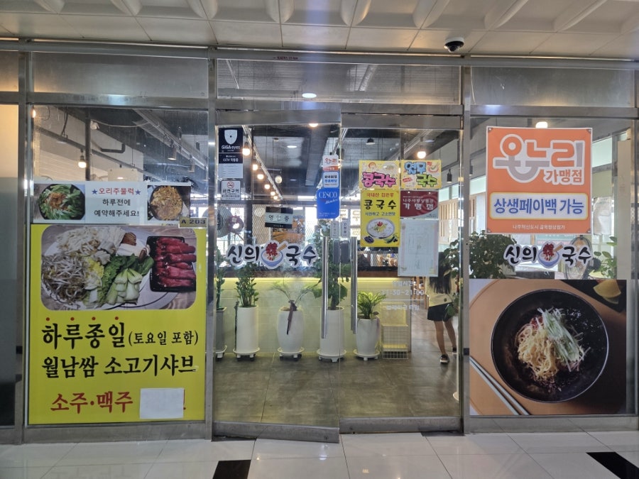 신의국수 매장 입구. 간판과 함께 월남쌈 소고기샤브, 오리주물럭 예약 안내, 온누리상품권 가맹점 표시가 붙어 있습니다.